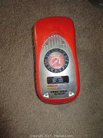 Top-down image showing front panel with pressure gauge and application details plate on the red casing