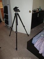 Manfrotto tripod with extended legs and attached 804RC2 tripod head in room setting