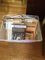 Plastic bin filled with vintage sheet music and music books dated from 1901 to early 2010, various genres visible including classical and popular.