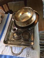 Silver-plated tray holding the bowls and candle holders, showing tarnish and wear.