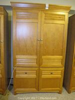 Front view of full wooden media center cabinet showing two large doors and two bottom drawers with rectangular and lined design.