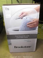 Photo of the boxed Brookstone towel warmer showing the product image and branding.