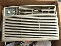 Front view of Westinghouse window air conditioner with vent grille and two control knobs.