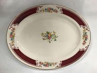 Full view of the Homer Laughlin oval serving platter showing the floral design with burgundy band and gold trim.