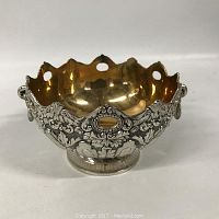 Front view of silver plate bowl showing gilt interior and detailed ornate exterior design with scalloped rim and pedestal base.