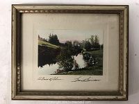 Front of framed color photographic print titled 'A River of Lebanon' signed by David Davidson. Shows river scenery with trees and grass.