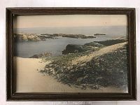 Framed vintage color photograph showing dunes and ocean with rocks