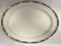 Top-down view of the large oval platter showing the cream surface and the floral trim around the edge.