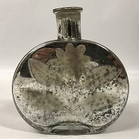 Front view showing etched flower and leaf design on mercury glass bottle.