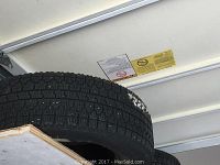 Side view of a black tire showing tread details and condition