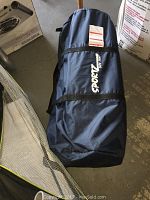 Blue carrying bag with Sportz SUV Tent branding, bag zipped and equipped with shoulder straps.