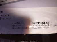 Close-up of the side of the boxed portable cooking range showing model THP-21S and Toastess International contact information.