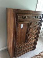 Angled front view of dresser showing 7 drawers and cupboard door closed