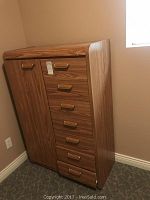 Front view of wardrobe showing 7 drawers on right side and cupboard door on left with gold-tone handles