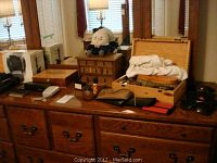 View of dresser top showing wooden boxes, tools and pouches