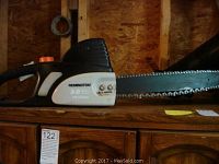 Side view of Remington chainsaw showing full bar and chain and power rating