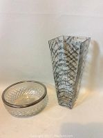 Overall view of both glass items: clear textured bowl and music note decorated vase