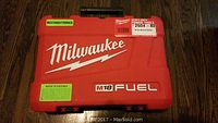Closed red hard plastic Milwaukee carrying case with M18 Fuel branding and reconditioned label