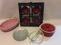 Full lot showing sushi serving components: glass plates, pink ceramic basket, red ceramic pot, and black tray with red dipping bowls.