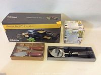 Boska cheese raclette mini set boxed with appetizer knives, cheese slicer in original packaging, and dip bowl.