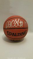 Front view showing Doug Christie autograph and Spalding logo on basketball.