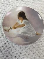 Photo of a collector plate titled 'Making Friends' showing a girl in a white dress playing with a small cat.