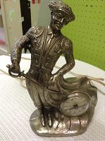 Full view of the metal matador figurine clock showing intricate details and clock location.