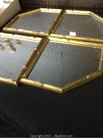 Top-down view of four connected octagonal mirrors with gold bamboo style frames, displayed on black surface.