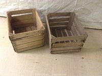 Two wooden crates shown from a top-down angled perspective, showing worn wood and slatted construction.