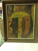 Overall view of the oil painting showing abstract face with earthy green, brown, and yellow tones in a wooden frame.
