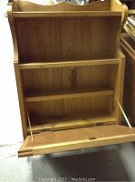 Full view of the cabinet showing the interior with three shelves and fold-down front door supported by chains.