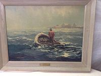 Full view of framed print of a fisherman on a boat in rough seas.