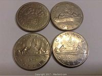 Four Canadian dollar coins from 1971, 1972, 1975, and 1976 showing obverse and reverse sides with relief images.