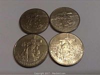 Four 1984 Canadian dollar coins depicting Jacques Cartier, silver colored, laid out on flat surface.