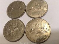Four Canadian circulated one dollar coins showing dates 1968, 1969, 1970 Manitoba edition, and 1976, silver-colored metal coins with visible wear.