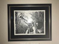 Framed black and white lithograph featuring man playing trumpet, image taken indoors showing size and framing.