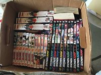 Top view of an open box containing 26 manga volumes including Bleach volumes 1-9 and Shonen Jump series volumes approximately 3 to 11