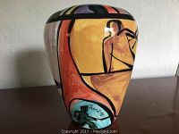 Front view of the vase showing a stylized figure playing basketball or similar sport with signature 'GWG 98' on a yellow and orange background.
