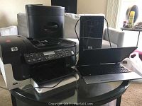 Photo showing Samsung laptop, HP desktop tower, HP OfficeJet 6500 printer, and Royal 1212X shredder on glass table