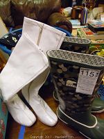 White Sorel rain boots with gray and black circle pattern, size 10, labeled with MaxSold tag.