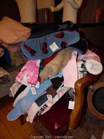 Pile of assorted boy and girl clothing of various sizes and colors including fleece and soft fabric items.