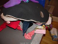 Pile of assorted children's clothing showing varied designs and colors.