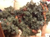 Artificial Christmas greenery with pine cones and small berries.