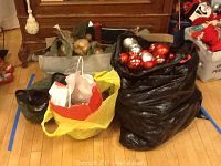 Bags filled with various Christmas decorations; one bag shows red and silver Christmas balls.