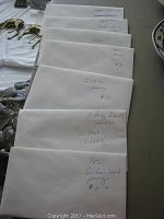 Envelopes containing various old U.S. coins with handwritten labels indicating coin type and approximate value.
