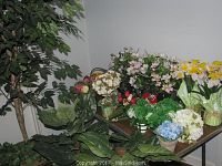 A wide view showing an array of faux flowers including roses, daffodils, flower balls, hydrangea clusters, and a large 82-inch fig tree in the corner.