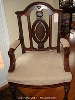 Front-facing view showing carved wooden back, flame stitch fabric upholstery on seat and arms, outlining shape and fabric condition.