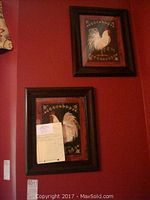Photo showing two framed rooster pictures on wall, both with dark brown wooden frames, size about 15x18 inches