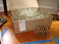 Box containing multiple clear cut glass items including bowls and a vase.