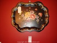 Vintage black painted serving tray with floral design and scalloped edges